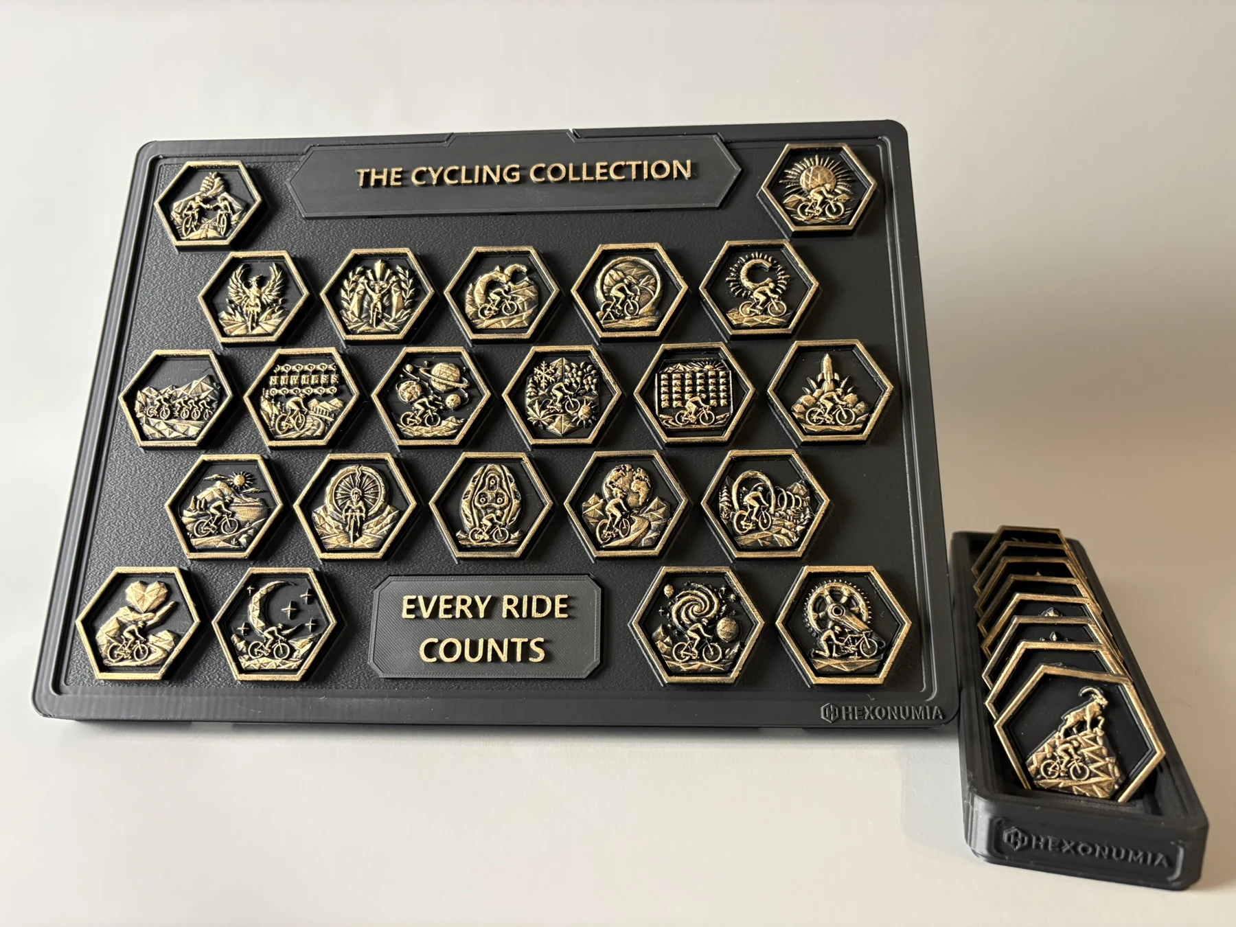 Physical Hexonumia Cycling board beside the companion token vault