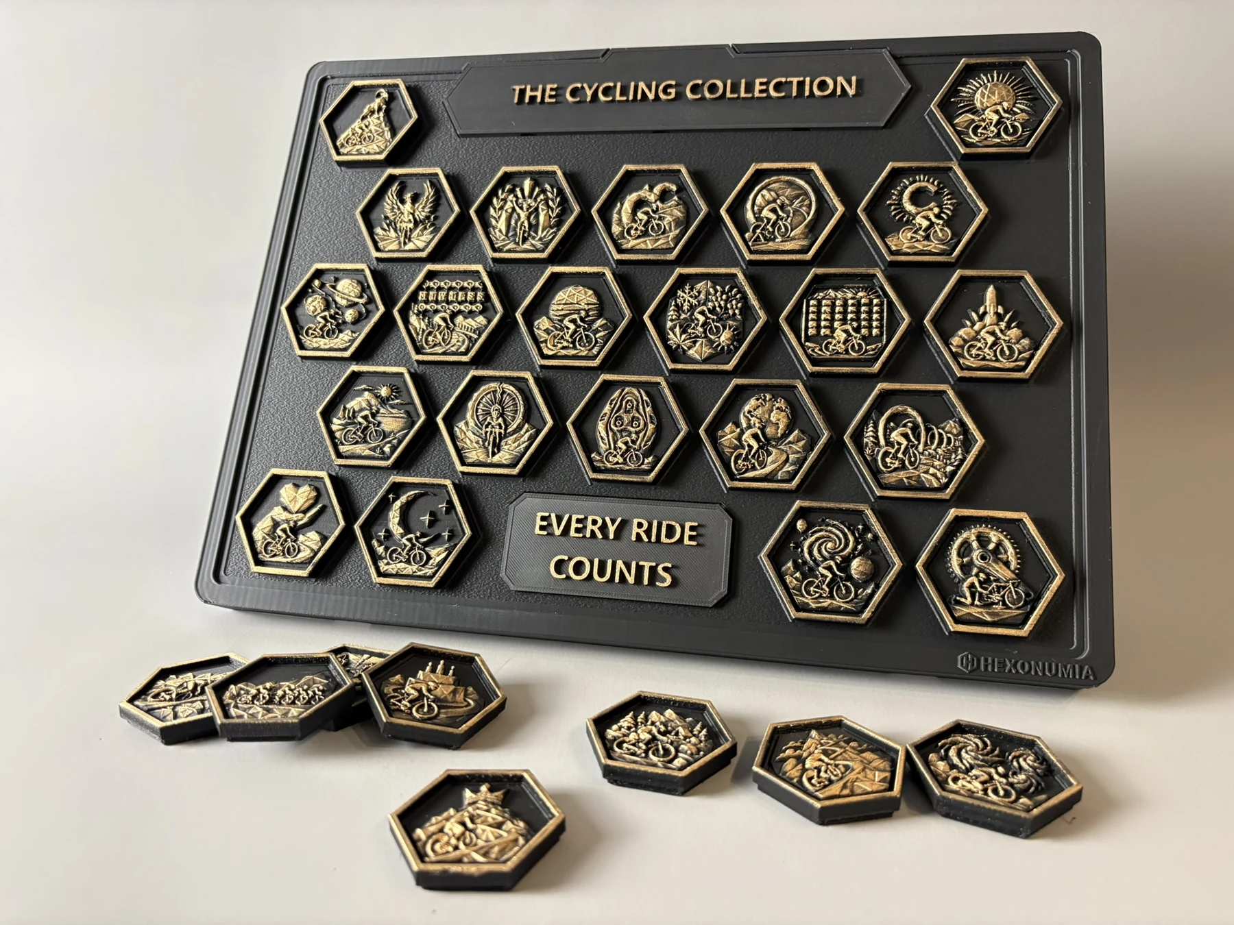 Hexonumia Cycling display with hand-finished achievement pieces on and off the board