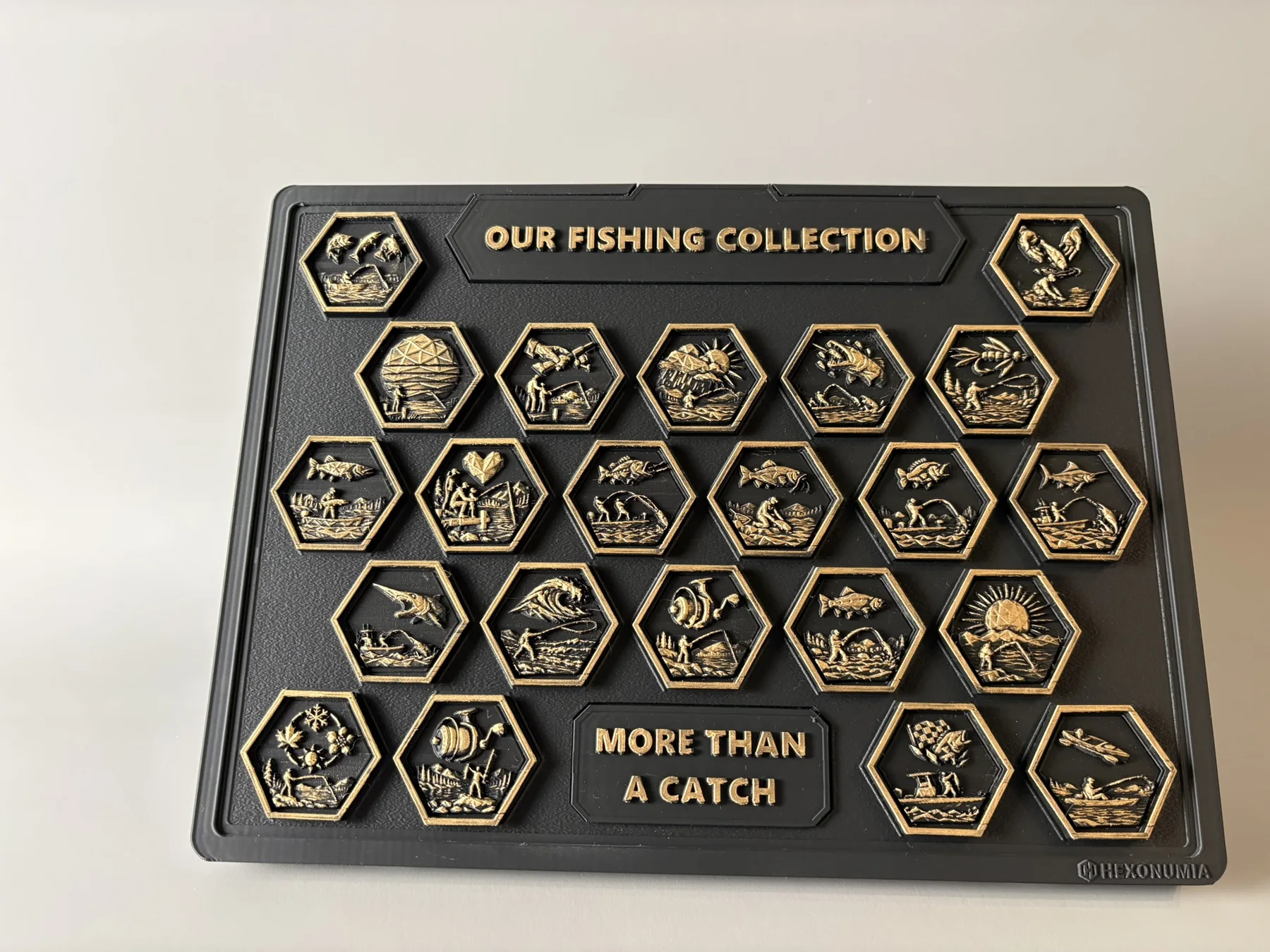 Front view of the physical Hexonumia Fishing display showing hand-painted relief pieces