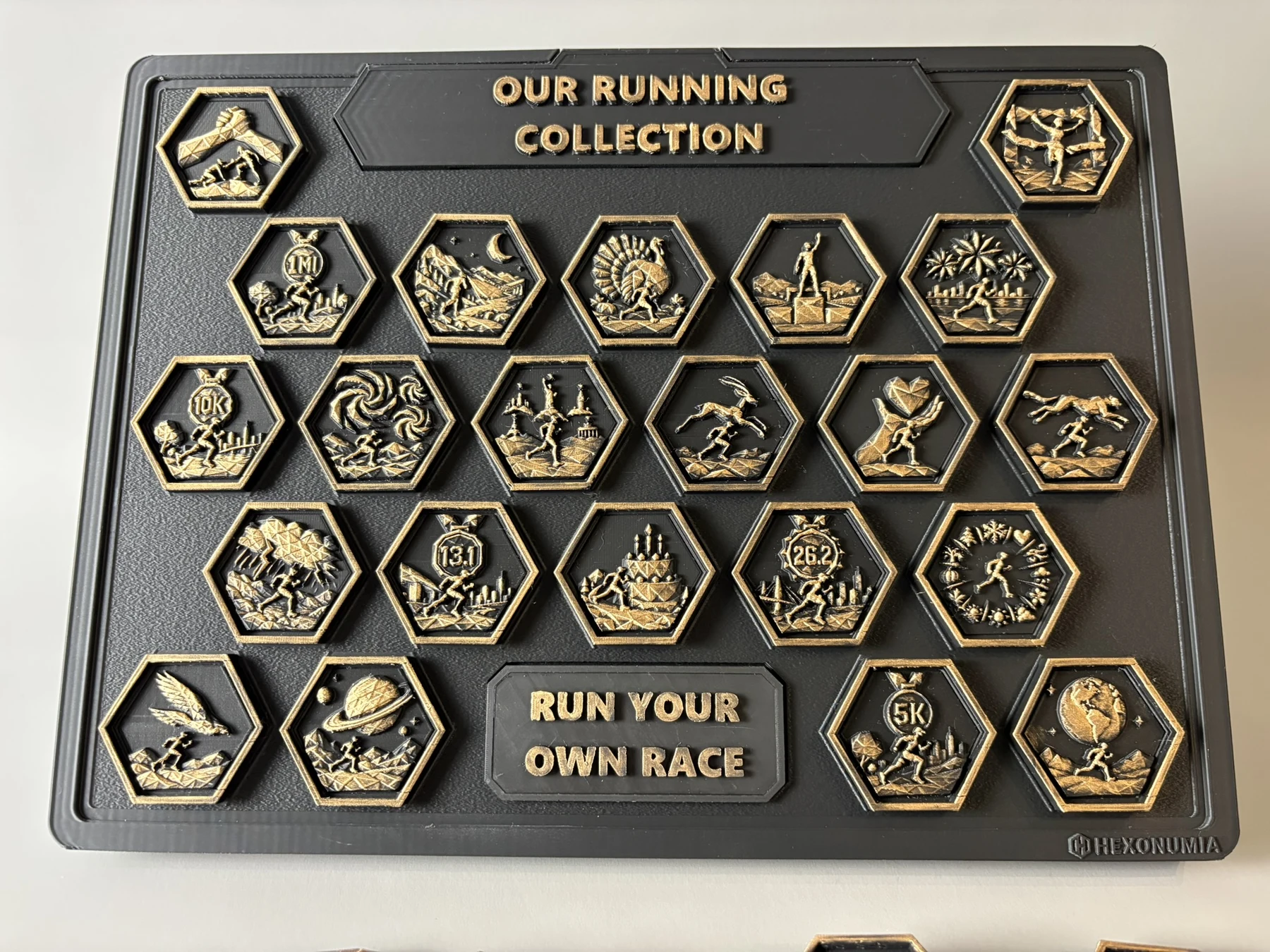 Front view of the physical Hexonumia Running display showing hand-finished relief pieces