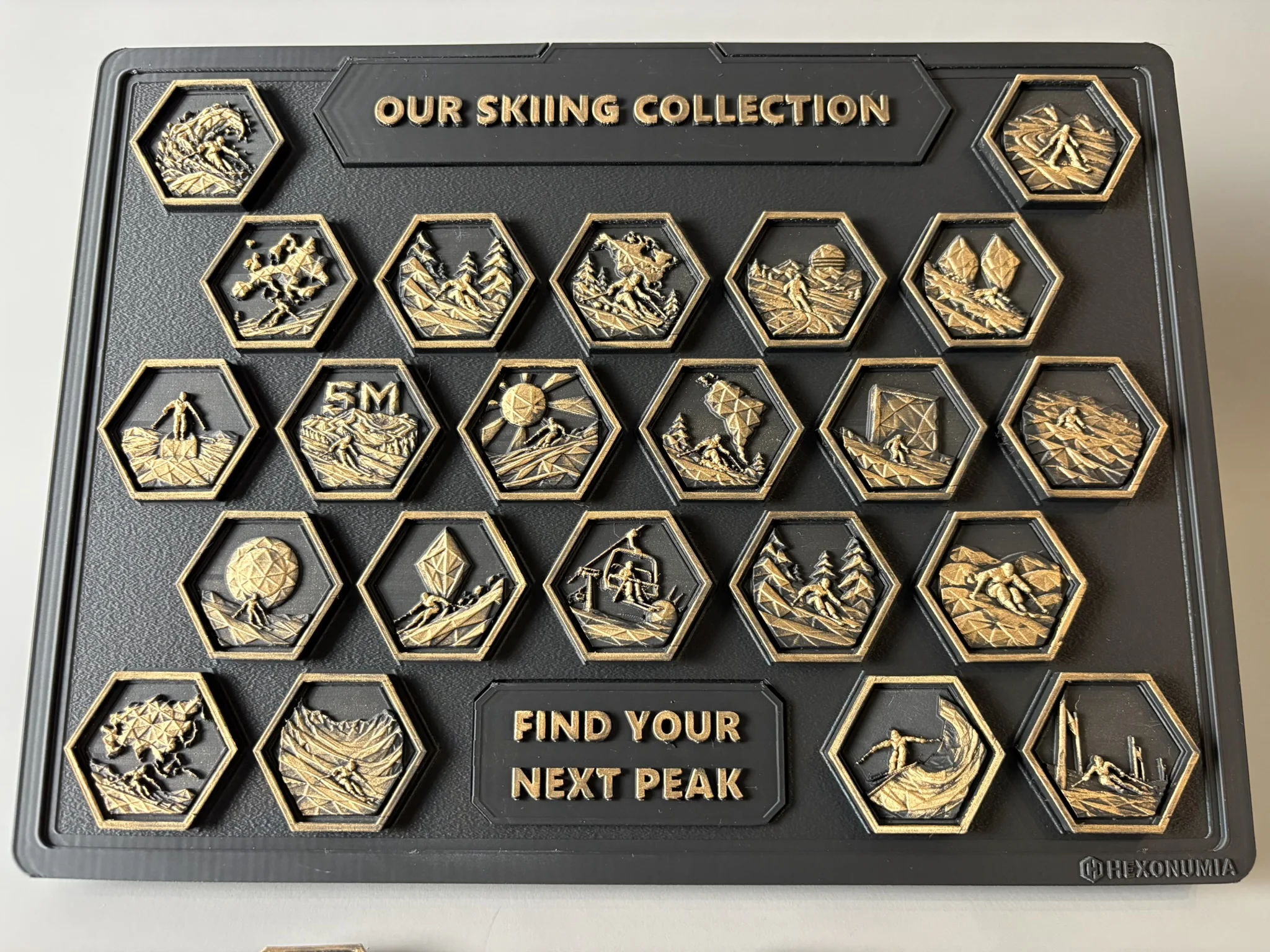 Front view of the physical Hexonumia Skiing display showing hand-finished relief pieces