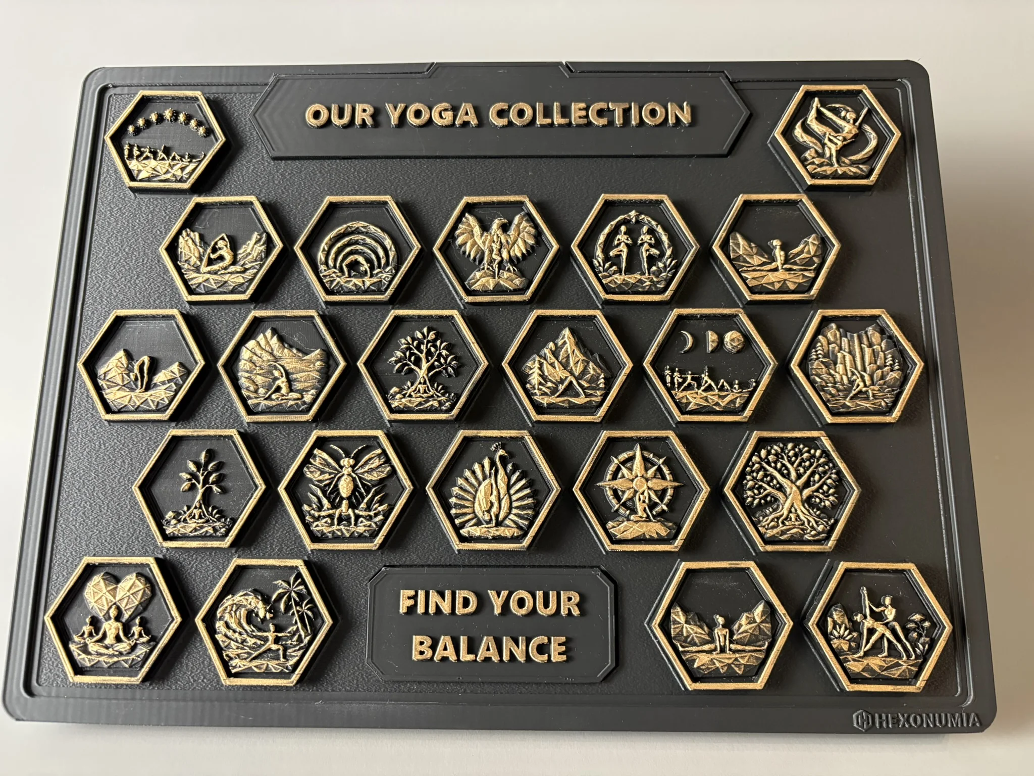Front view of the physical Hexonumia Yoga display showing hand-finished relief pieces
